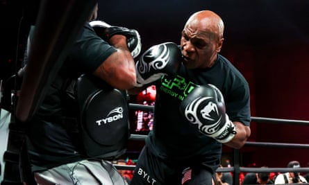 Mike Tyson throws punches during an open workout session to prepare for a heavyweight bout against Jake Paul