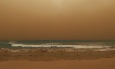 A beach in Geraldton, Western Australia is covered in red dust from hundreds of kilometres away during cause by ex-Tropical Cyclone Mangga which has delivered wild weather across WA.