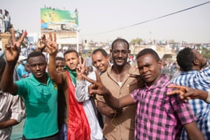 Demonstrators take part in a protest demanding the departure of Sudanese president, Omar al-Bashir, as they wait for an announcement outside the Sudanese Army headquarters