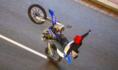A US urban dirt-bike rider performs a wheelie on-street. The ‘urban rodeo’ culture is also popular in France, and common in the areas around Paris. 