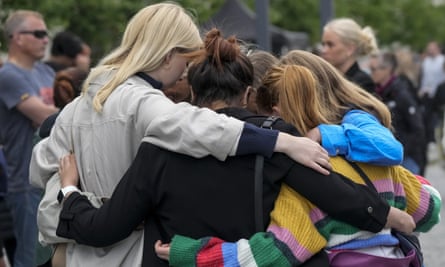 People comfort each other at a memorial service to the victims of a mass shooting in Copenhagen.