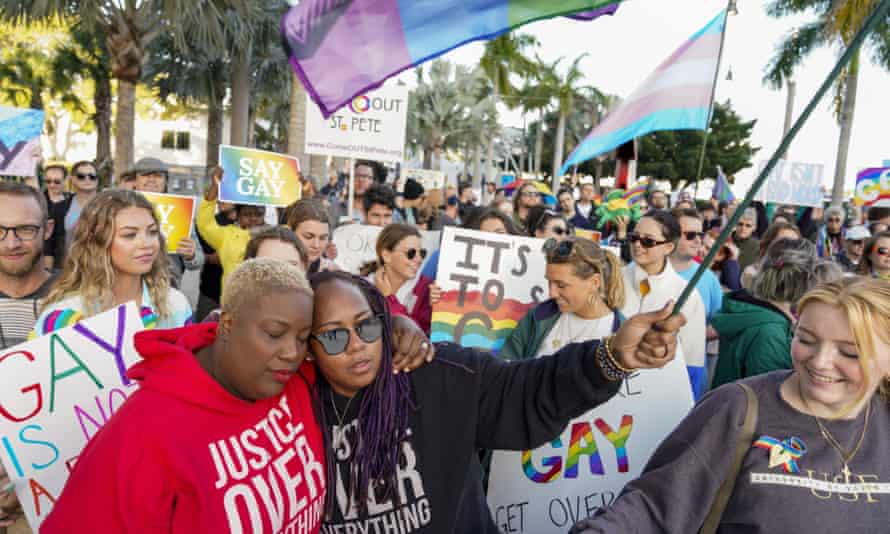 people hold signs and wave flags