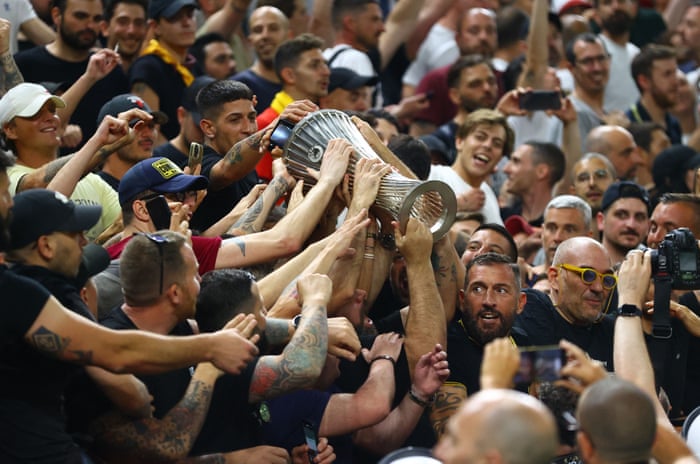 Roma fans celebrate with the trophy after their team win the Europa Conference League