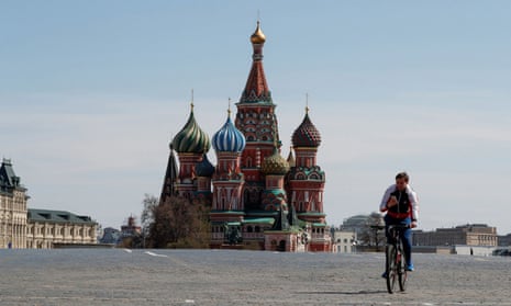 A lone cyclist rides through an almost completely empty Red Square in Moscow on 1 May. 