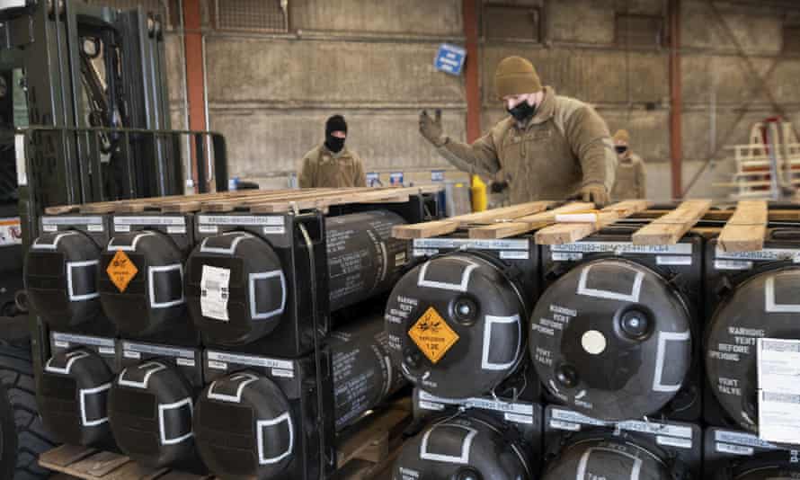 Airmen and civilians from the 436th Aerial Port Squadron palletize ammunition, weapons and other equipment bound for Ukraine during a foreign military sales mission at Dover Air Force Base, Delaware.