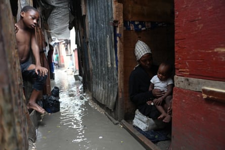 Families displaced by gang violence endure flooding brought by Hurricane Melissa.