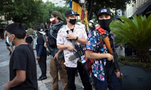 A Texas Guerrillas member who calls himself 'Apex', third from right, and others carry weapons at a Black Lives Matter rally in Austin, Texas.