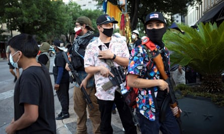 A Texas Guerrillas member who calls himself ‘Apex’, third from right, and others carry weapons at a Black Lives Matter rally in Austin, Texas.