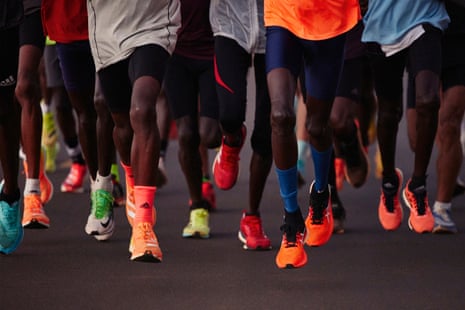 A group of runners' legs in DayGlo trainers, from the series The Runners of Iten by Shamil Tanna.