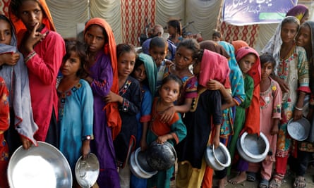 people queue with food bowls