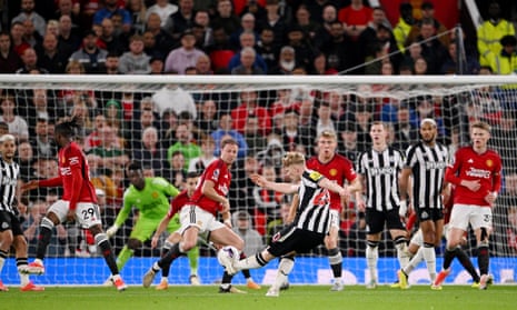 Lewis Hall of Newcastle United scores his team's second goal during the Premier League match at Manchester United.