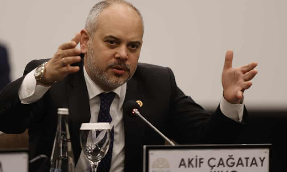 Akif Çağatay Kılıç speaking into microphone.