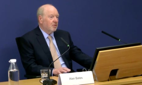 Alan Bates at sits at a desk as he gives evidence to the inquiry in Aldwych house, London