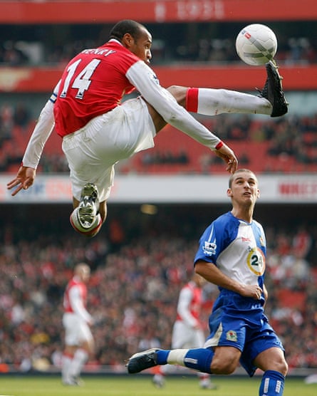 Thierry Henry controls the ball in the air next to David Bentley.