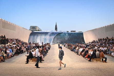 Catwalk covered in sand in centre of Paris outside with wave backdrop