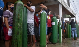 Relatives of patients infected with Covid-19 queue to refill oxygen tanks at the Carboxi company in Manaus, Amazonas state, Brazil. (Photo by Marcio James/AFP via Getty)