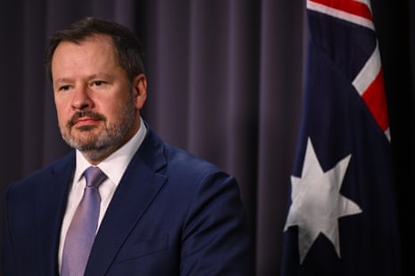 A man with short hair and a dark suit.