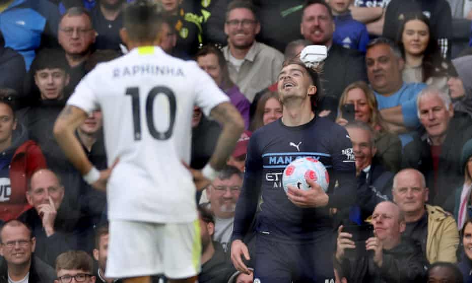 Jack Grealish heads a paper ball thrown at him by Leeds fans during Manchester City’s 4-0 win.