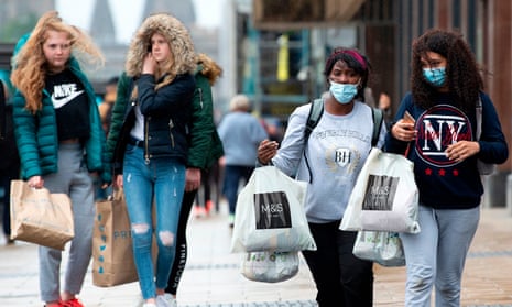 Shoppers in Edinburgh, some wearing masks, others not
