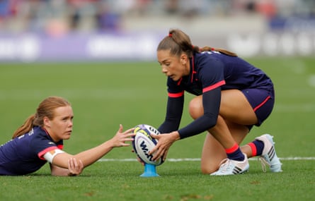 England’s Holly Aitchison (right) lines up a conversion while tMia Venner steadies the smaller ball in the wind.