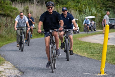 US President Joe Biden rides his bike at Gordons Pond in Rehoboth Beach, Delaware, on August 3, 2023.