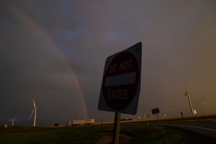 A rainbow over the highway against dark clouds near Weatherford, Texas