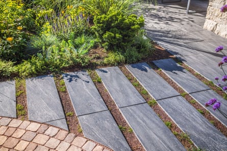 Path with large stone slabs through a beautifully planted garden