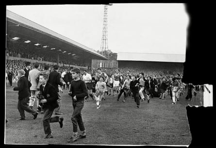 Ipswich fans celebrate on the pitch at Portman Road.