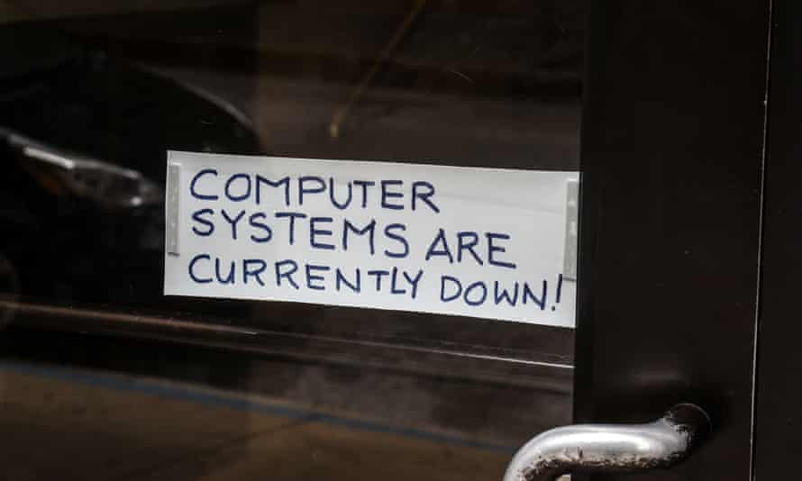 A sign referring to the hacked computer system of Baltimore City is taped to a door near Baltimore City Hall in Baltimore, Maryland