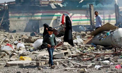 A boy walks through ruins in Sana'a