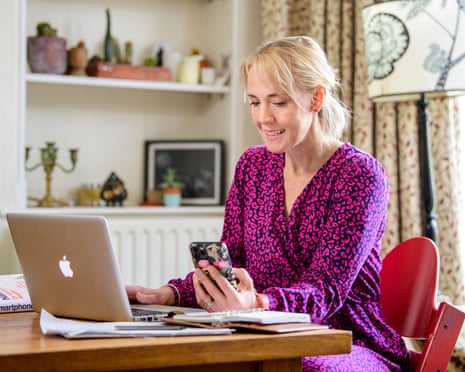 Geddes sat in room working on laptop and looking a smartphone
