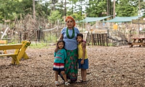 A refugee woman and her children inside the Friends of Refugees community garden in Clarkston, Georgia. 