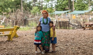 A refugee woman and her children inside the Friends of Refugees community garden in Clarkston, Georgia.