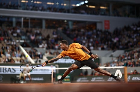 Gaël Monfils plays a backhand at Roland Garros.