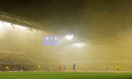 Smoke from the flares of the Borussia Dortmund fans engulf Stamford Bridge.