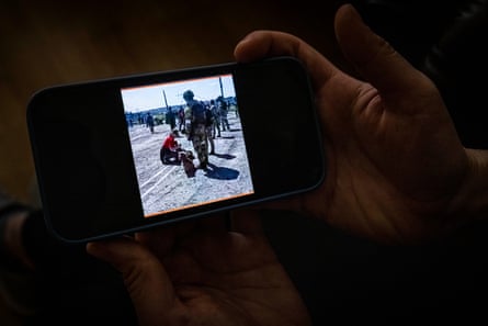 Alina Panina shows a picture on her phone of her being searched by a Russian soldier.