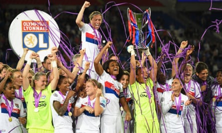 Match winning goalkeeper Sarah Bouhaddi lifts the trophy as her team-mates celebrate Lyon’s fourth European victory.