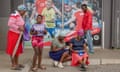 Customers place their bets outside a sports betting shop in the Soweto township of Johannesburg, South Africa, December 2022