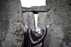 A person gestures during winter solstice celebrations at Stonehenge near Amesbury