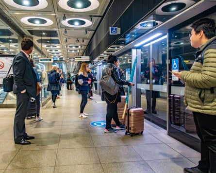 People lasting connected an underground level immoderate with roller suitcases