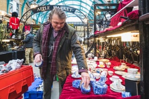 Market traders in Covent Garden setup their stalls for the first day of trading this year after non-essential retail reopens on April 12, 2021 in London, United Kingdom. England has taken a significant step in easing its lockdown restrictions, with non-essential retail, beauty services, gyms and outdoor entertainment venues among the businesses given the green light to re-open with coronavirus precautions in place. Pubs and restaurants are also allowed open their outdoor areas, with no requirements for patrons to order food when buying alcoholic drinks. (Photo by Joseph Okpako/Getty Images)