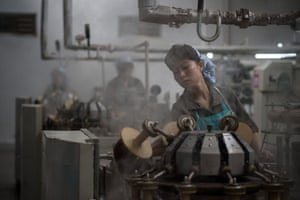 Pyongyang, North Korea: A worker operates machinery at a silk mill