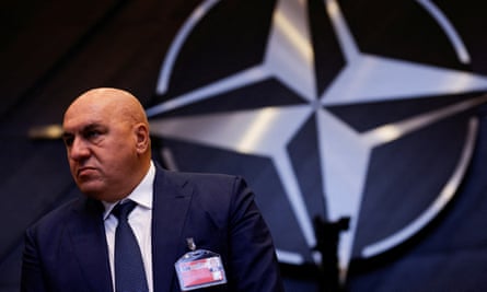 Guido Crosetto pictured in front of the Nato logo 