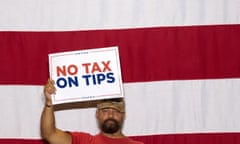 a person holds a sign that reads 'no tax on tips'