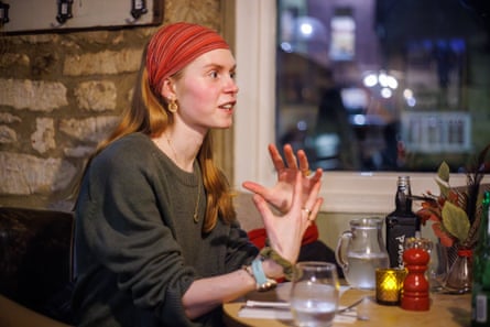 Matilda sitting at a restaurant table chatting and gesticulating