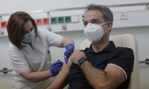 Greece’s prime minister Kyriakos Mitsotakis receives a shot of the first dose of the Pfizer-BioNTech vaccine against coronavirus in Athens