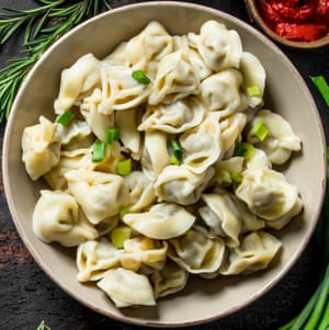 Dumplings with beef and tomato paste. On dark rustic background