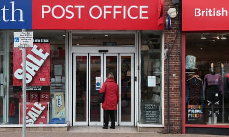 A woman standing in the doorway of a post office