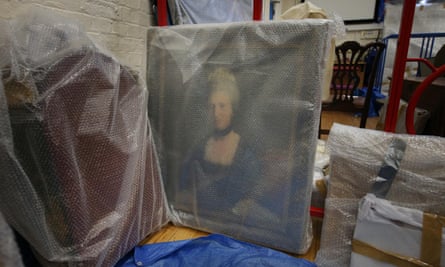 A portrait of Henrietta Shelley, Countess of Onslow, sits wrapped in bubble wrap for protection after being rescued from the blaze.