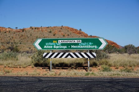 A road sign with the English names crossed out and replaced with Aboriginal names near Alice Springs, Northern Territory, Australia.